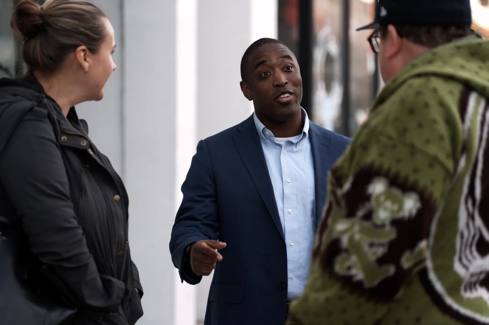 Lorenzo Santos talking with residents on a Wisconsin sidewalk